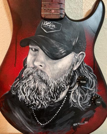 Chad Sullins guitar painted by artist, Nathan McCray, was auctioned live from the Grand Casino Main Stage at Eskimo Joe’s.